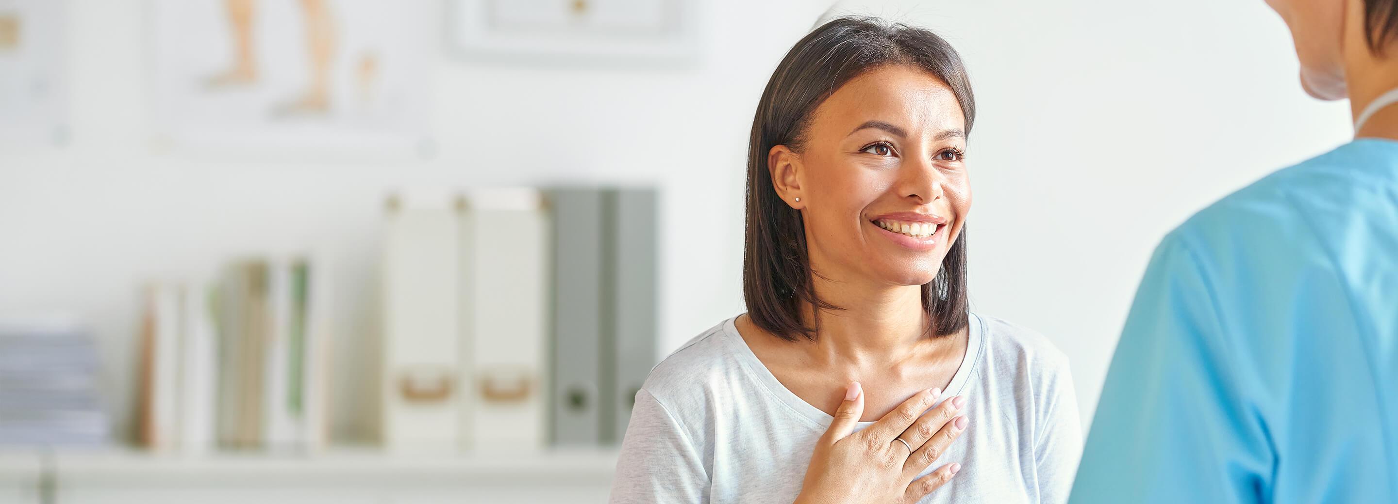 Happy patient speaking with her doctor